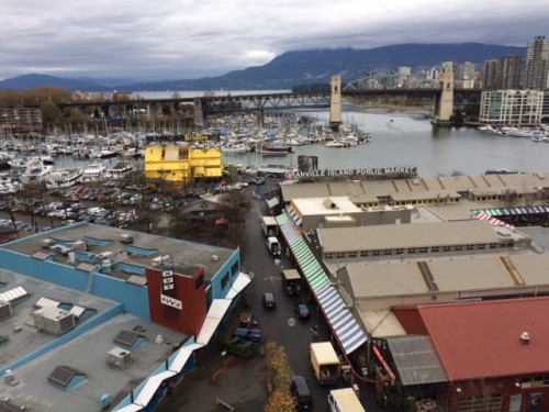 Granville Island from the Granville Bridge. The body of water is False Creek. The Burrard Street Bridge is in the background.