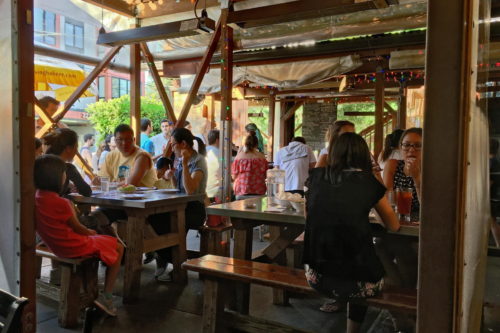 The "interior" of Pok Pok. Notice the french fry lamps above the tables for colder evenings. (Yes, the restaurant is open to the elements.)